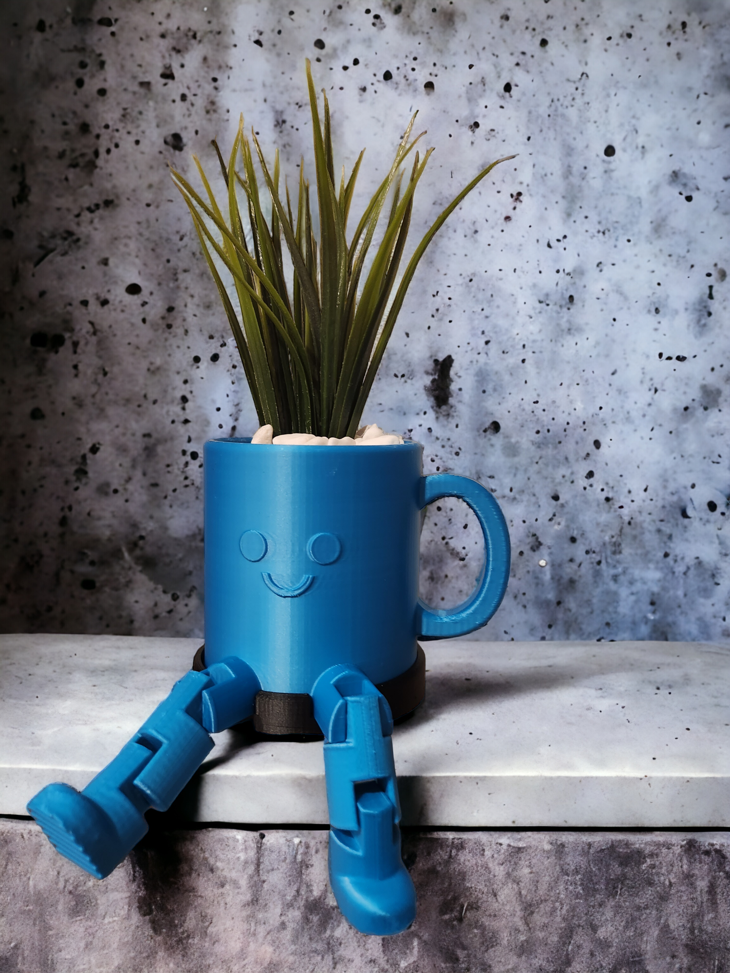 Coffee cup planter with smiley faces and legs.